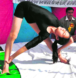 A participant performs yoga in a summer camp in Haridwar on Tuesday.
