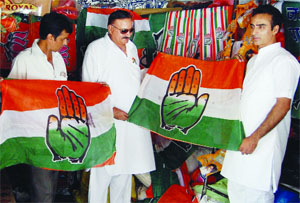A party worker purchases publicity material ahead of MC elections from a shop in Amritsar