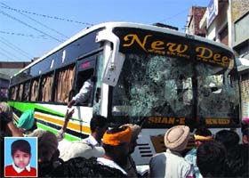 The bus that ran over a school kid (inset) bore the public wrath at Talwandi Bhai in Ferozepur district on Wednesday morning