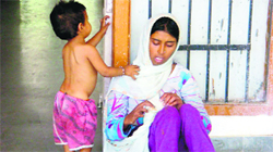 Pooja with her son at the Mini Secretariat in Fatehabad on Tuesday. Photo by writer