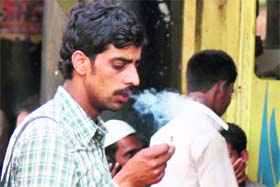 A man puffs away at the Jammu bus stand