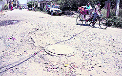 Commuters have a tough time crossing rough patches on Gujja Peer Raod in Ward 22 in Jalandhar