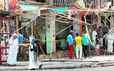 Residents at the site of a blast in Baghdad on Thursday. 