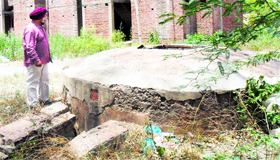 A resident shows a well in Challi Khoo Park, which is in a shambles, in Ward 18 in Amritsar.