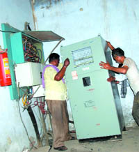Workers install a new high-tension meter worth Rs 35,000 at the Circuit House in Bathinda on Friday. The power to the Circuit House could be restored only after 8 pm.