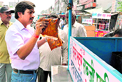 An official of the Health Department inspects food items being sold on a roadside eatery in Haridwar on Friday
