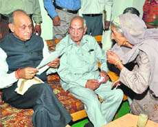  Chief Minister PK Dhumal listens to the grievances of an elderly woman at Jahu on Friday. 