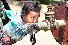 A child tries to drink water from a tubewell on a hot Friday afternoon in Jalandhar. The maximum temperature recorded in Jalandhar was 43 C