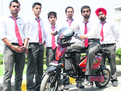Students of CT Institute demonstrate the working of a detachable electric bike in Jalandhar on Friday. Tribune photo: Malkiat Singh