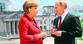 With the Reichstag building in the background, Russias President Vladimir Putin with German Chancellor Angela Merkel on the roof of the Chancellery in Berlin.