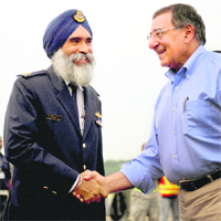 US Defence Secretary Leon Panetta is greeted by Singapores Commander of the Air Power Generation Command, Col Sarbjit Singh in Singapore.