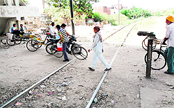 Bad road condition and the absence of gates at a railway crossing make it risky for residents in Ward 53 in Amritsar