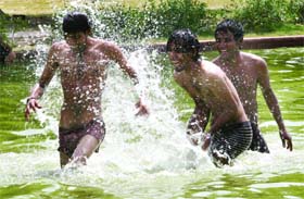 Boys cool off at Boat Club in New Delhi on Saturday