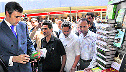 Chief Minister Omar Abdullah checks out a book during a fair at SP College in Srinagar on Saturday
