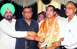 MLA and BJP leader Manoranjan Kalia welcomes a Congress worker into the BJP fold in Jalandhar on Saturday