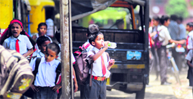 A schoolchild quenches his thirst outside a school in Ludhiana.