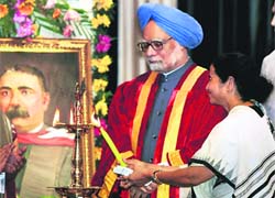 PM Manmohan Singh looks on as Mamata Banerjee lights a lamp at the Indian Science Congress in Kolkata. 