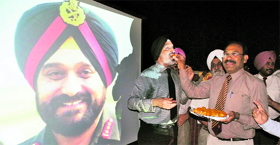 Dignitaries distribute sweets at Punjab Public School, Nabha, on Friday.