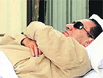Ousted Egyptian president Hosni Mubarak is wheeled into an ambulance following his verdict hearing in Cairo
