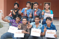 Winners of the maiden Bathinda District Chess Championship flash victory sign while posing for the media on Sunday. 