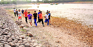 With no water, rowing club members now jog on the lakes bed