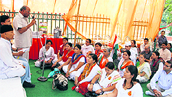 Supporters of Ramdev hold a dharna in Dehradun on Sunday