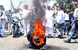 Congress Sewa Dal activists burn tyres in protest against Ramdev in Haridwar on Sunday