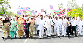 Farmers take out a protest march on the GT Road against the acquisition of their land on Sunday.