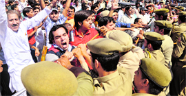 VHP and Bajrang Dal activists run into a wall of police personnel.