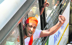 An activist raises a slogan after being detained in Jammu on Sunday.