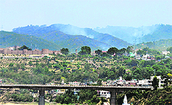 Smoke continues to billow on the second day from a section of the Mohmaya forest area where a fire had broken out on Saturday in Jammu