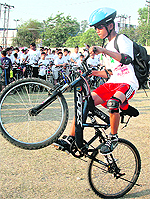 A participant performs a stunt during the Jammu Cyclothon on Sunday