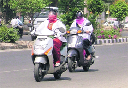 Women protect themselves from scorching heat in Ludhiana on Sunday. photo: inderjeet verma