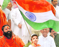 Anti-corruption activist Anna Hazare with yoga guru Ramdev in New Delhi on Sunday. Tribune photo: Manas Ranjan Bhui