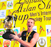 New Zealands Dean Couzins celebrates with the trophy after winning the Sultan Azlan Shah Cup. 
