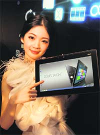 A model displays the ASUS TAICHI, an ultraportable notebook with a double-sided LED-backlit IPS/FHD display, during a news conference in Taipei on Monday