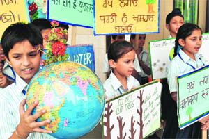 Schoolchildren participate in an awareness rally on the eve of World Environment Day in Patiala on Monday.