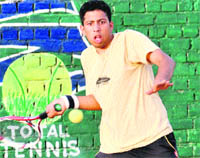 Nikhil plays a shot during the Paragon Total Tennis Tournament at Sector 17 in Mohali. 