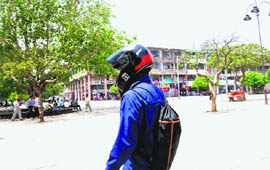 A boy wears a helmet to save himself from the sun at Sectot 17 in Chandigarh on Monday.
