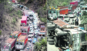 Traffic came to a halt on the Dehradun-Delhi highway after a truck (right) overturned near the Dat Kali tunnel on Monday. 