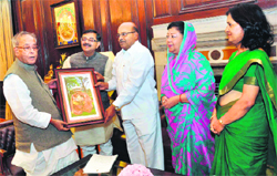 A delegation, led by BJP Rajya Sabha MP Tarun Vijay, presents a photograph of Nanda Devi Raj Jat Yatra to Union Finance Minister Pranab Mukherji in New Delhi on Sunday.