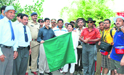 District Magistrate, Pithoragarh, CMS Bisht flags off the first batch of the Kailash Mansarowar yatra at Dharchula on Monday. 