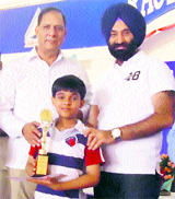 Harshit Arya receives the first prize from the organisers of the Haryana State Chess Championship in Sirsa.