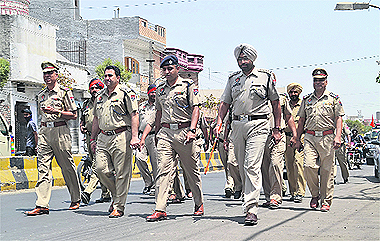 Ahead of MC polls, police officials conduct a flag march in Jalandhar on Monday.