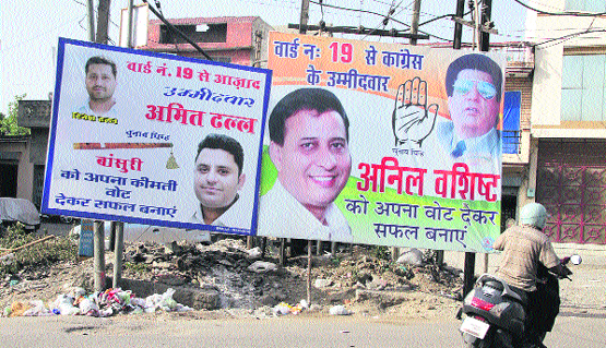 Hoardings of two candidates fixed on a power transformer near the Domoria Bridge in violation of the election code of conduct in Jalandhar. Photo: Sarabjit Singh