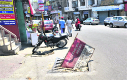 A manhole with a damaged lid, which poses a danger to commuters, in Jammu city. 