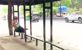 A bus shelter in a dilapidated condition.