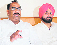 State BJP president Ashwini Sharma, flanked by MP Navjot Singh Sidhu, addresses mediapersons in Amritsar on Tuesday