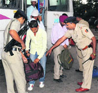 Police personnel conduct a check at the Inter-State Bus Terminus in Sector 43 of Chandigarh on Tuesday. 