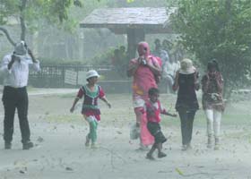 PLEASANT SURPRISE: People enjoy the wet weather in Delhi on Tuesday